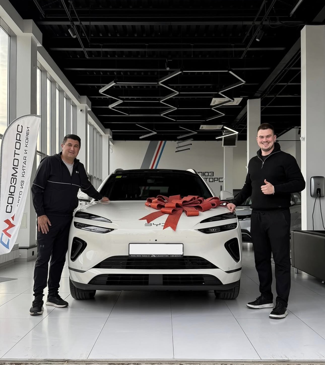 Customer standing beside BYD vehicle outdoors